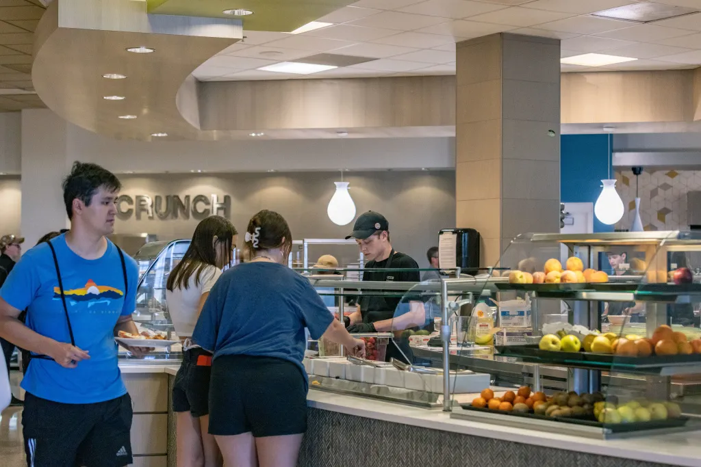 students grabbing food in the dining hall on campus