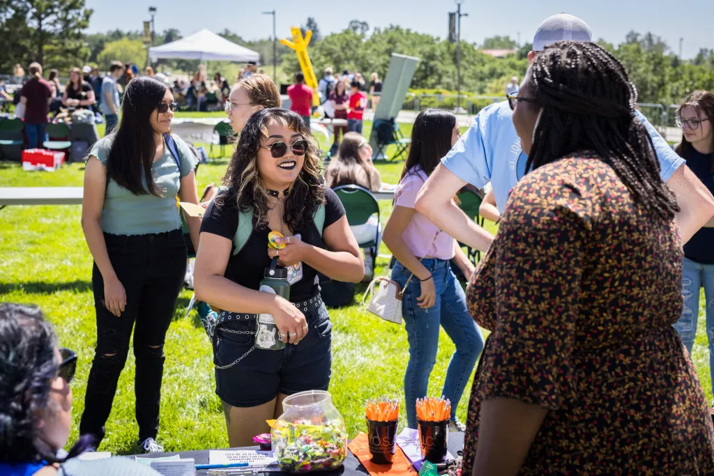 student talking to a booth at the uccs clubfair